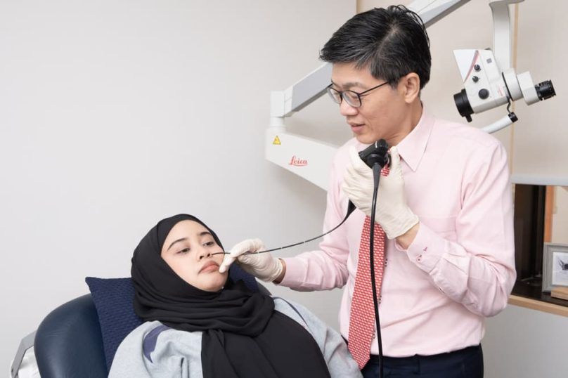 ENT specialist assessing a patient for nasal blockage at Advanced Sinus and Skull Base Centre, Singapore